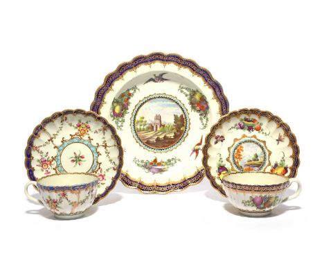 Two Worcester cups and saucers, c.1780, of fluted form, one painted in the Dalhousie manner with a landscape panel within fru