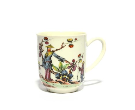 An early Worcester coffee cup, c.1755, boldly enamelled with a Chinese figure pointing down to a small boy, standing before f