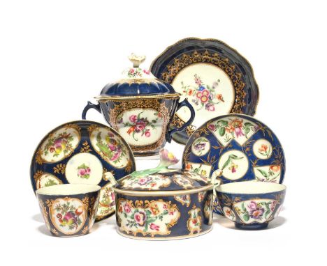 A Worcester chocolate cup with cover and stand, c.1760, of ogee form, painted with panels of flowers, reserved on a wet blue 