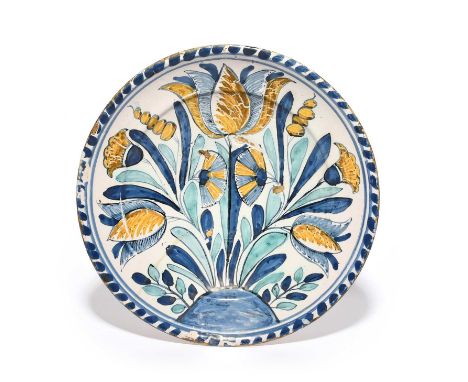 A delftware blue dash tulip charger, c.1690-1700, probably Bristol or Brislington, painted in blue, green, yellow and ochre w