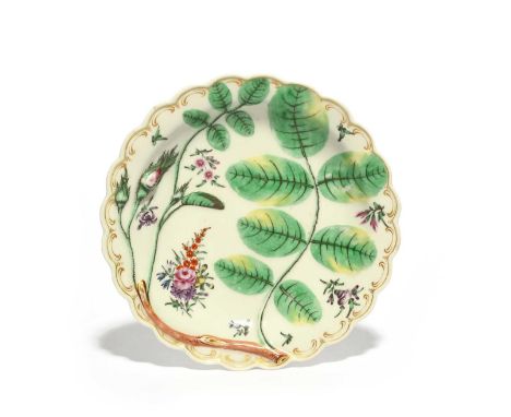 A Worcester Blind Earl plate, c.1770, moulded and painted with a rosebud and leaves, painted inbetween with small sprays of f