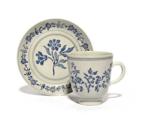 A Doccia coffee cup and saucer, c.1745-50, decorated a stampa with stencilled decoration in underglaze blue of flowering bran