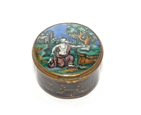 A Limoges enamel patch box, probably 19th century, decorated with a haloed saint kneeling and resting one hand on a stone tab