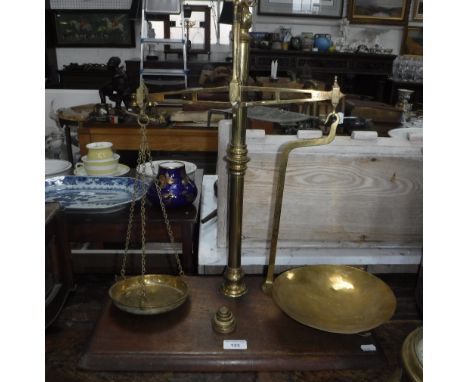 A SET OF 19TH CENTURY BRASS SCALES with weights, on a mahogany base