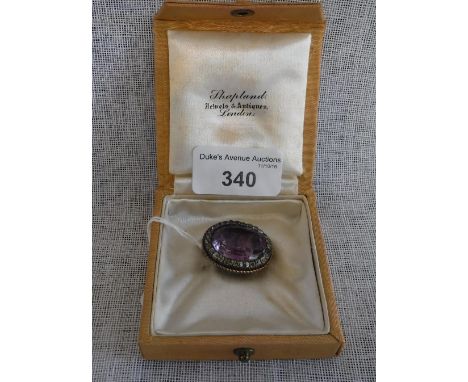 AN EARLY 19TH CENTURY FOILED AMETHYST AND PASTE-SET CLUSTER BROOCH in a Shapland, London box