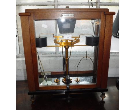 A SET OF 'OERTLING' CHEMIST'S SCALES in a glazed mahogany case