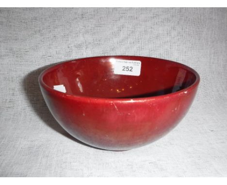 A CARTERS POOLE RED LUSTRE GLAZED POTTERY BOWL