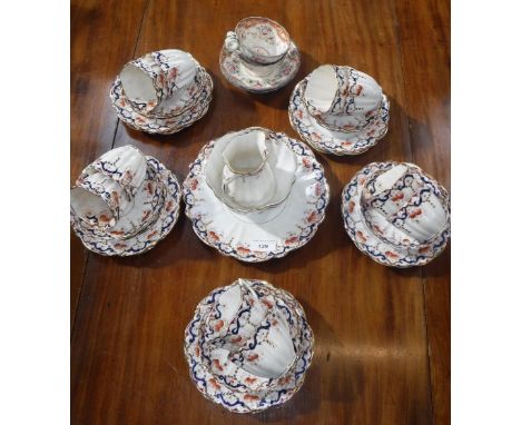 AN EDWARDIAN TEA SET with floral swag and gilt decoration and two similar cups with saucers