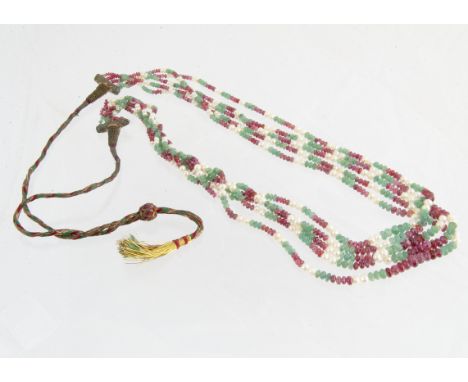 A mid 20th Century Indian multi strand ruby, emerald and seed pearl necklace, the polished emerald and ruby beads alternately