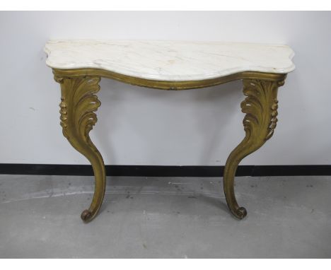 A 19th Century Rococo style continental serpentine gilded console table, shaped marble top with carved wooden acanthus  leaf 