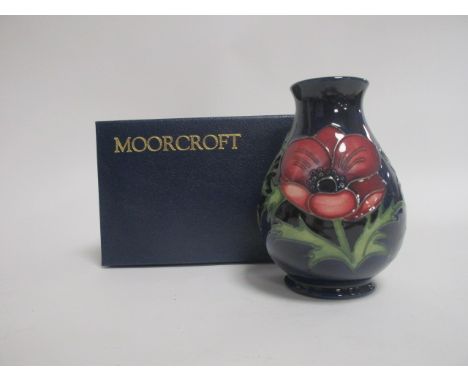 A contemporary Moorcroft pottery vase, of footed baluster form, in the 'Anemone' pattern, with impressed factory marks to the