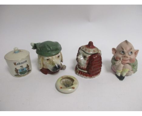 An early 20th Century novelty German tobacco jar in the form of a grotesque boy with thumb raised up to his lips,  height 15c