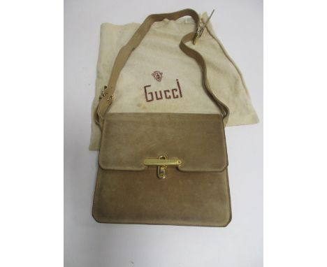 A vintage Gucci beige suede shoulder bag, with a brown leather adjustable strap and gilt metal clasp to flap closure, leather