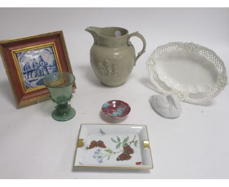 A Dutch Delft blue and white tile depicting Jesus carrying the cross, framed, together with a Limoges rectangular dish, Spode