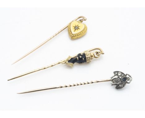 Three stick pins including a diamond set bug,  a heart with gypsy set diamond and figure with a blackamoors head, 