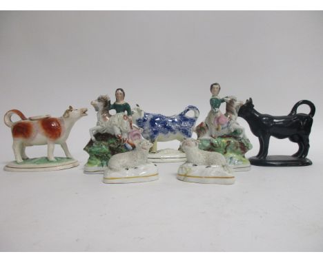 Three Victorian ceramic cow creamers,  one Jackfield black, 16cm x 13cm, one sponge ware example and another hand painted and