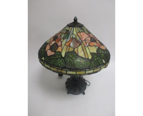 A Tiffany style lamp, decorated in poppies, on a cast metal base, height 63cm