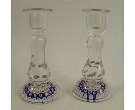 A pair of glass candlesticks, with clear glass stem and baluster wrythen sconce, raised on a millefiori base, height 5.75insC