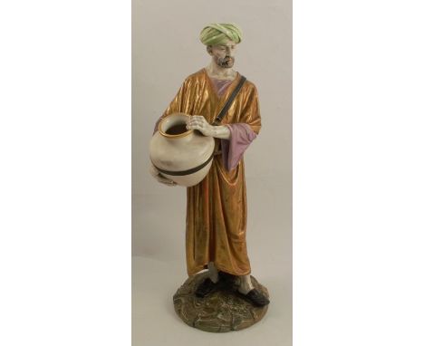 A 19th century Royal Worcester figure of an Eastern water carrier, stamped Hadley to the base, a man holding a pitcher, heigh