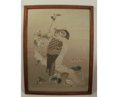 A Japanese tapestry picture, of an owl on a bench&nbsp;with flowers, 26ins x 19ins