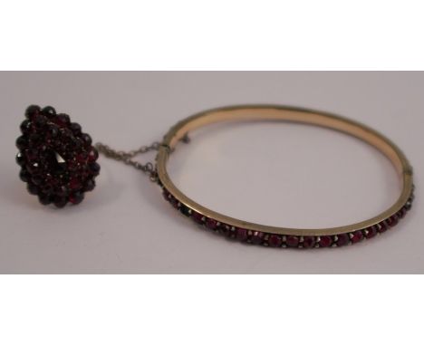 A Bohemian garnet cluster ring, of tear shape, finger size M, 5.2g gross, together with a similarly set hinged bangle