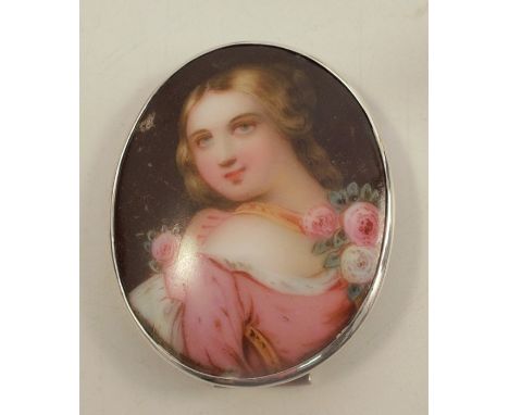 Four framed oval porcelain plaques, three decorated with still lives of flowers and the fourth with a portrait of a girl, in 