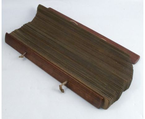 An Indonesian palm leaf manuscript, Hindu text, Bali, enclosed by hardwood slats and tied with string, 16.5ins, together with