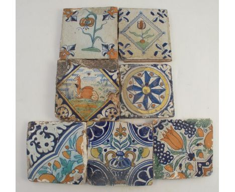 Seven various tiles, some decorated in the Eastern style, with tulip heads and other flowers, one with a camel of possibly a 
