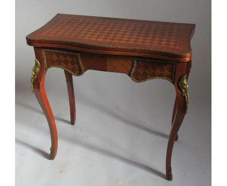 A swivel topped card table, with parquetry inlay and gilt metal mounts, raised on cabriole legs, width 29.25ins, height 31ins