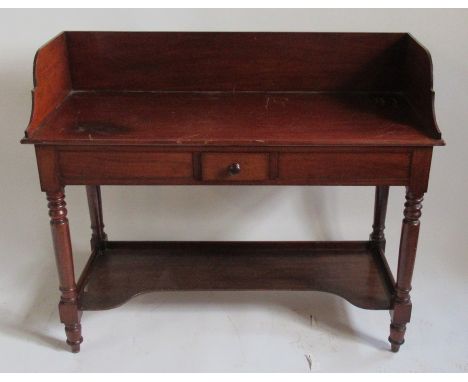 A 19th century mahogany wash stand, with a high tray back, fitted with a short central drawer and raised on turned legs unite