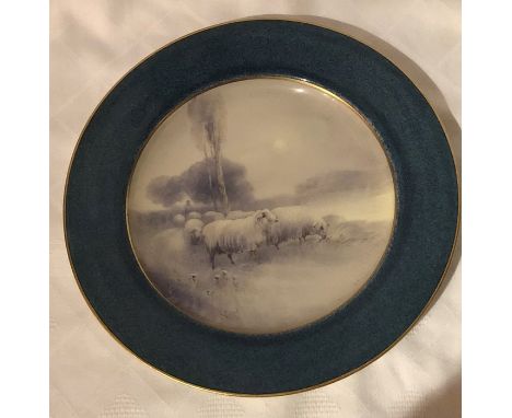 A Royal Worcester plate, decorated with sheep in a winter landscape, to a blue border by H Davis, circa 1919, diameter 9ins