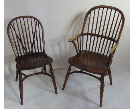 A stick back saddle seated Windsor armchair, with crinoline stretcher, together with two similar single chairs