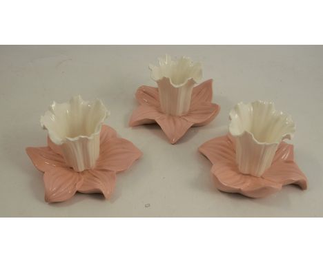 A set of three Graingers Worcester lily leaf centre pieces, the white flower raised on a pink leaves, shape number G103, heig