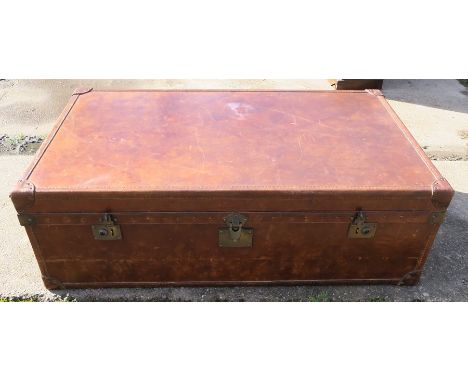 A rectangular leather trunk, being part studded, having four carrying handles and divided interior, inscribed Bond Street, Lo