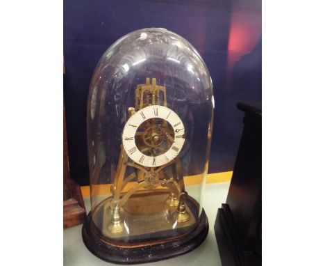 A Victorian brass skeleton clock of pyramid form with fusee movement, enamel chapter ring and Roman numerals, the foot plate 