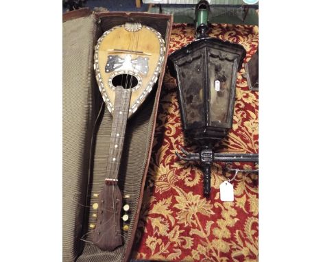 An Italian mandolin with mother or pearl inlay banded together with a Mario Cassella Catania outside metal wall lamp  Orange 