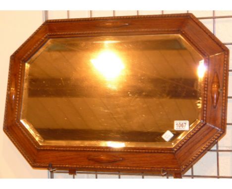 MIRROR. Octagonal oak framed bevel edged mirror 