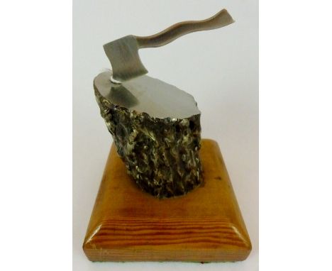 Vintage stainless steel and wooden axe in tree trunk trophy