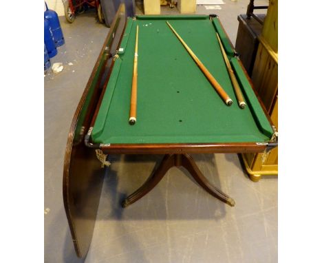 Mahogany dining table on double pedestal with pool table underneath. 