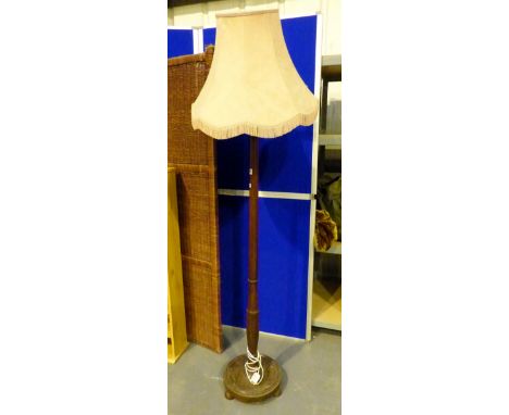 Single piece turned wood standard lamp.