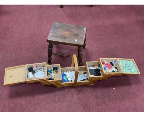 Light Wood Sewing Box with concertina opening 32.5cm wide when closed, plus contents, ash stool on four turned splayed feet (