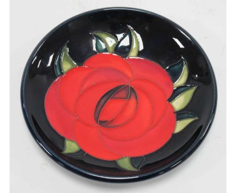 A Moorcroft Pottery Coaster, decorated in the 'Red Rose' design by Emma Bossons, shape 780/4, impressed and painted marks, 12