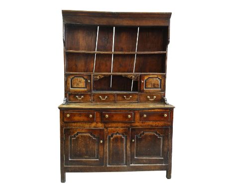 A SMALL CHARACTERFUL OAK NORTH WALES CUPBOARD-BASE WELSH DRESSER early to mid-18th Century, having a base of two panelled cup
