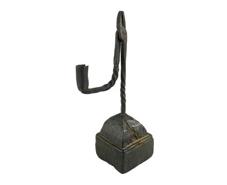 AN 18TH CENTURY WROUGHT IRON RUSH LIGHT HOLDER the iron work in two sections joined by a single rivet, both sections twisted 