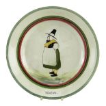 A LLANELLY POTTERY PLATE BY SHUFFLEBOTHAM of circular form with a figure of Mari Jones of Bala in