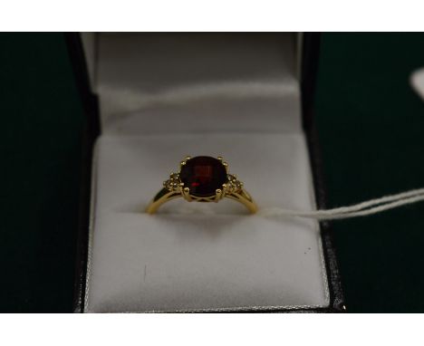 A 14ct gold, garnet and diamond ring, size P.