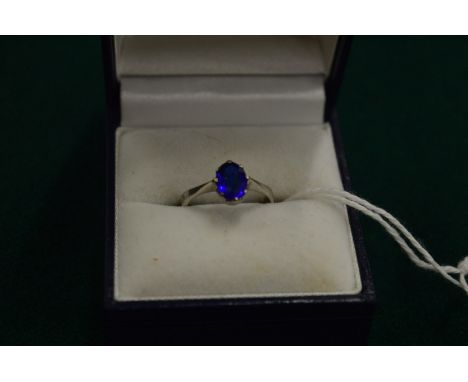 A 9ct gold ring set with a blue stone, size H.
