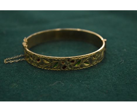 An engraved gilt metal bangle.