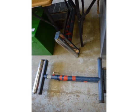 Two floor standing height adjustable timber roller supports.