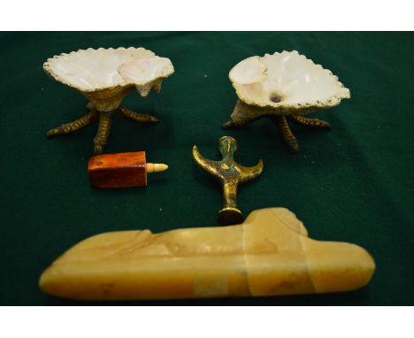 A pair of shell dishes, carved alabaster model of a sphinx and two other pieces.